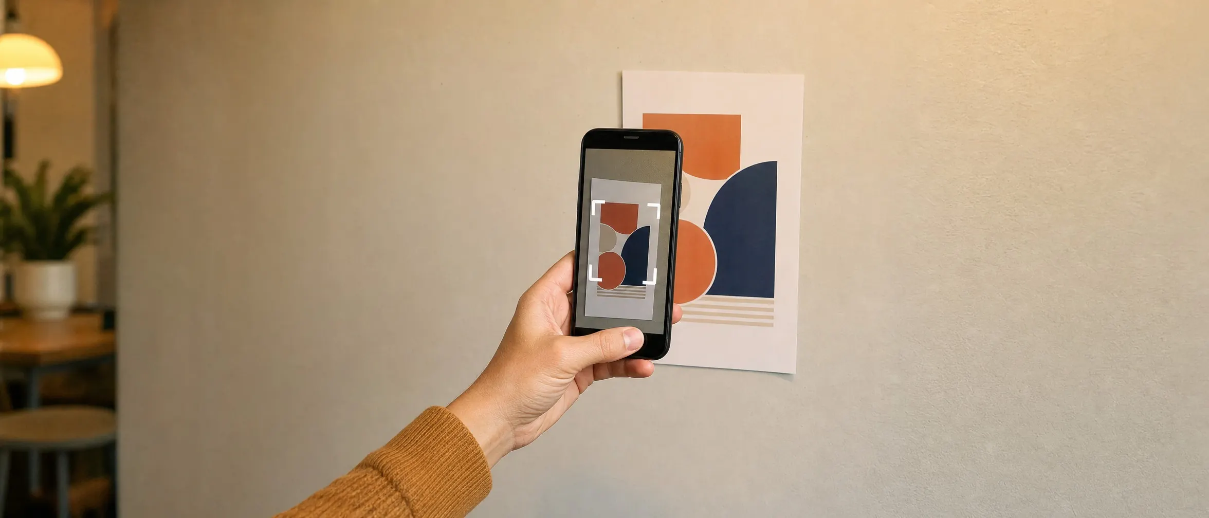 Hand pointing a phone camera at a printed poster mid-scan