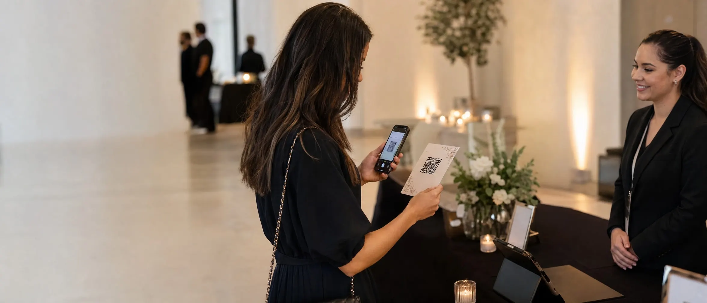 Person scanning a QR code on an event invitation at a registration table